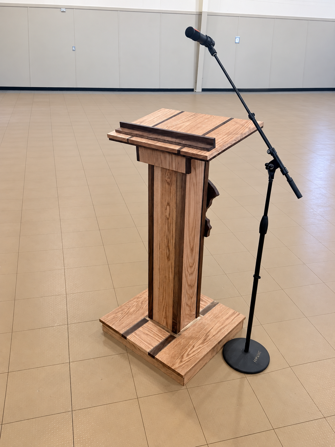 Side and rear profile of the hardwood podium, including its paneled central column and presentation surface