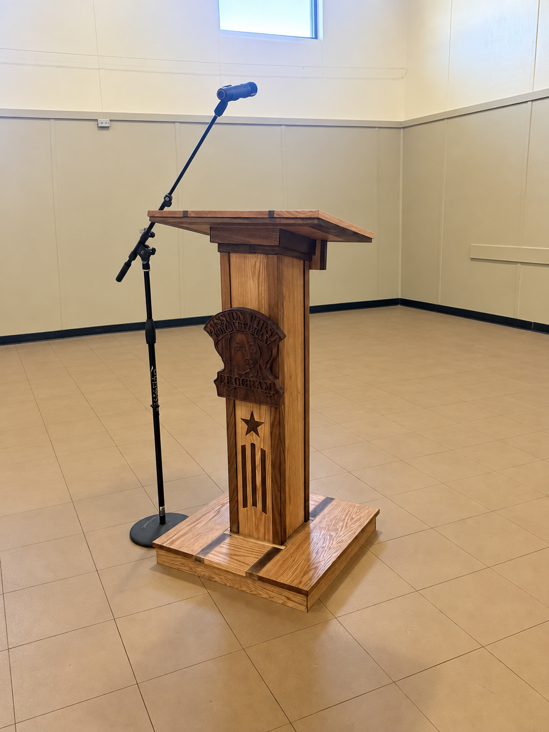 Three-quarter view of the completed hardwood podium showing its front, side and raised base